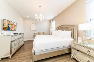 a bedroom with a large bed and a chandelier at Luxury Home With Themed Rooms, Air Hockey Near Disney With Waterpark & Resort Access At Encore Resort - 7699Gr in Kissimmee