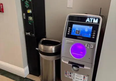 an atm machine in a room with a trash can at The Point Hotel & Suites - 705S Luxury - Pool view - Close to Universal in Orlando