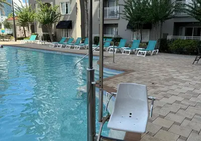 a swimming pool with lounge chairs in a hotel at The Point Hotel & Suites - 705S Luxury - Pool view - Close to Universal in Orlando