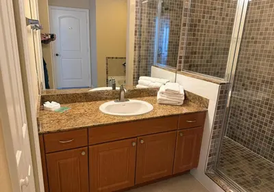 a bathroom with a sink and a shower at The Point Hotel & Suites - 503 Luxury - Pool view - Close to Universal in Orlando