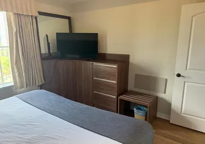a bedroom with a bed and a flat screen tv at The Point Hotel & Suites - 503 Luxury - Pool view - Close to Universal in Orlando