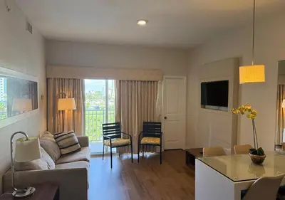 a living room with a couch and a table at The Point Hotel & Suites - 503 Luxury - Pool view - Close to Universal in Orlando