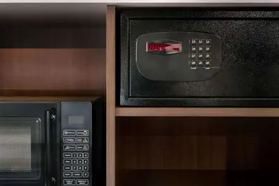a microwave oven sitting next to a black microwave at La Quinta Inn & Suites by Wyndham Orlando I-Drive Theme Parks in Orlando