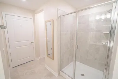 a bathroom with a shower with a glass door at Only 5 Miles from Disney! Free Water Park! 2 Bed, 2 Bath Condo, Sleeps 8 in Kissimmee