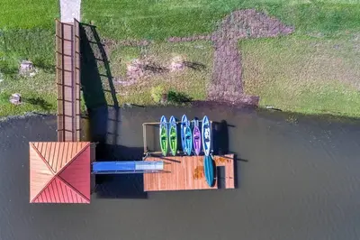 a group of surfboards sitting on a table in the water at I - New 4 Bedroom Home - 5 Miles to Disney - Free Water Park - Private Pool in Kissimmee
