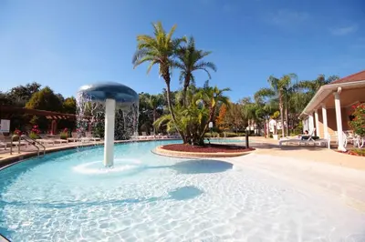 a large swimming pool with a fountain in the middle at 2956 Lucaya Village - Gorgeous Four Bed Condo Close to Disney Area in Kissimmee