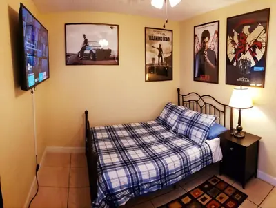 a bedroom with a bed and a flat screen tv at A1 Private Room With 55