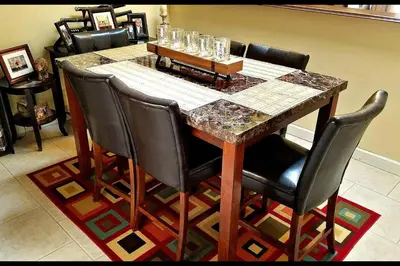 a dining room table with black chairs and a marble table at A1 Private Room With 55