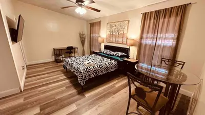 a bedroom with a bed and a table in it at D4 Large Private Master Room & Bath with 55