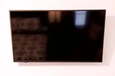 a flat screen tv hanging on a wall at D4 Large Private Master Room & Bath with 55