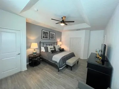 a bedroom with a bed and a ceiling fan at 3840 Supreme Villa 6Bd Private Pool and Game Room in Kissimmee