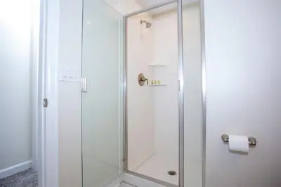 a shower with a glass door in a bathroom at Wonderful 5 Bedroom w/ Pool Close to Disney 4801 in Kissimmee