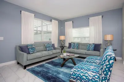 a living room with a couch and a table at Wonderful 5 Bedroom w/ Pool Close to Disney 4801 in Kissimmee