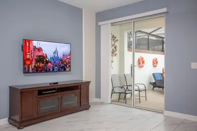 a living room with a flat screen tv on a wall at Wonderful 5 Bedroom w/ Pool Close to Disney 4801 in Kissimmee