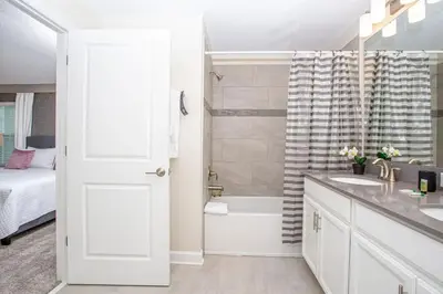 a bathroom with a tub and a sink and a toilet at Gorgeous 4 Bedroom w/ Pool Close to Disney 4836 in Kissimmee