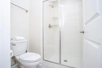 a white bathroom with a shower and a toilet at Gorgeous 4 Bedroom w/ Pool Close to Disney 4836 in Kissimmee