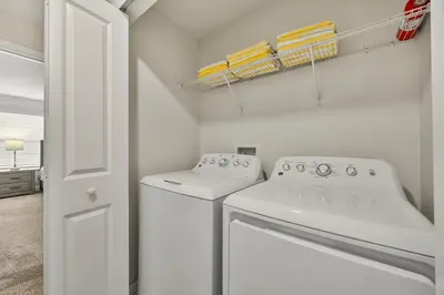 a white laundry room with a washer and dryer at Renewed Luxury Townhouse with private pool in Kissimmee