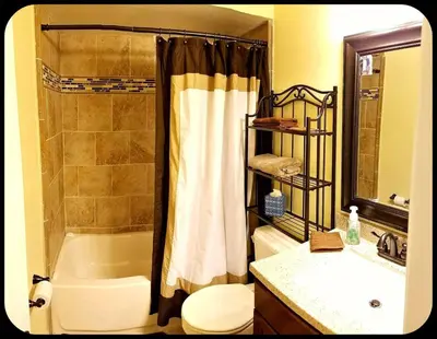 a bathroom with a tub and a toilet and a sink at B2 Private Room With 55