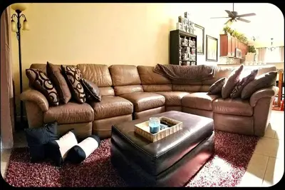 a living room with a brown leather couch at B2 Private Room With 55