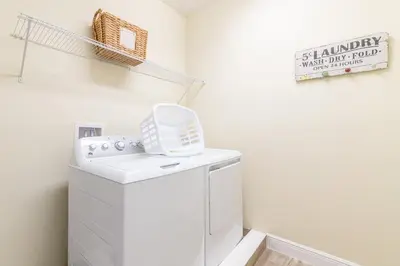 a white laundry room with a washer and dryer at Elegant Home Near Disney With Private Pool And Waterpark & Resort Access At Encore Resorts Reunion - 430La in Kissimmee