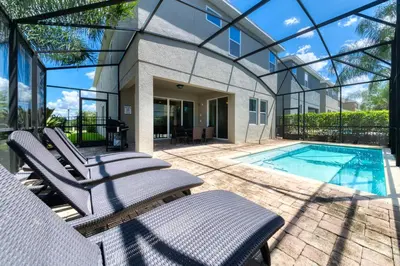 a house with a swimming pool and patio furniture at Elegant Home Near Disney With Private Pool And Waterpark & Resort Access At Encore Resorts Reunion - 430La in Kissimmee