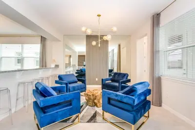 a living room with blue chairs and a mirror at Jedi Temple! Take A Virtual Tour Private Pool! Villa in Orlando