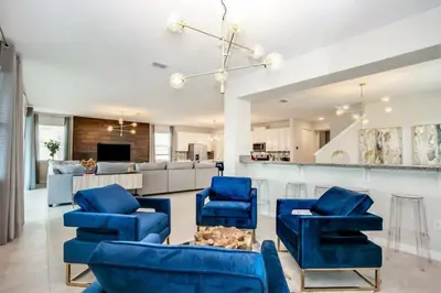 a living room with blue chairs and a kitchen at Jedi Temple! Take A Virtual Tour Private Pool! Villa in Orlando