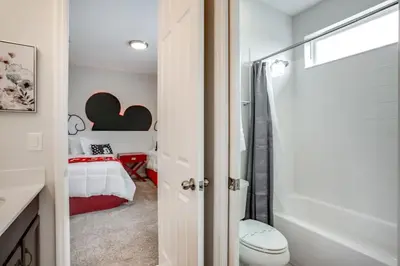 a bathroom with a bedroom with a bed and a toilet at Jedi Temple! Take A Virtual Tour Private Pool! Villa in Orlando