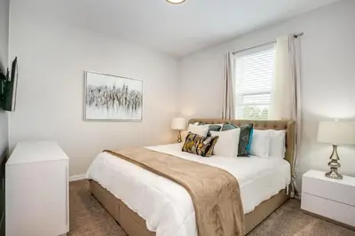 a white bedroom with a large bed and a window at Jedi Temple! Take A Virtual Tour Private Pool! Villa in Orlando