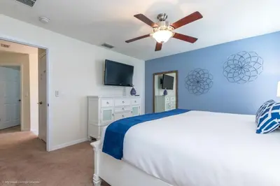 a bedroom with a bed and a ceiling fan at Bella Vidatown Home With Full Size Pool! Townhouse in Kissimmee