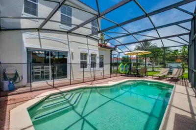a swimming pool with a glass roof over it at Bella Vidatown Home With Full Size Pool! Townhouse in Kissimmee