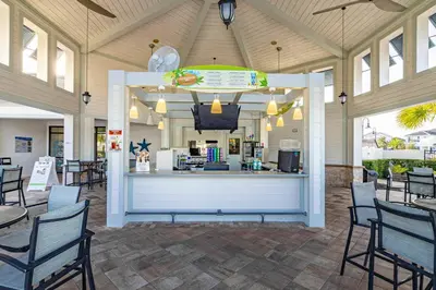 a restaurant with a counter with chairs and tables at Storey Lake - Private Pool Home 10 Min to Disney in Kissimmee