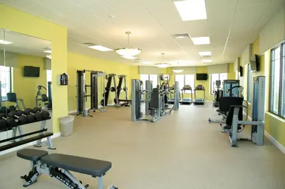a gym with rows of treadmills and machines at Storey Lake - Private Pool Home 10 Min to Disney in Kissimmee