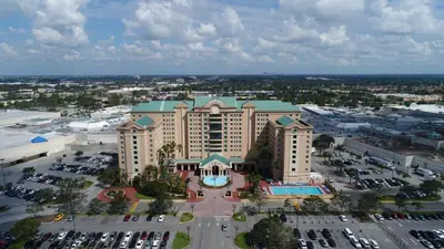 an aerial view of a large building with a parking lot at The Florida Hotel & Conference Center in the Florida Mall in Orlando