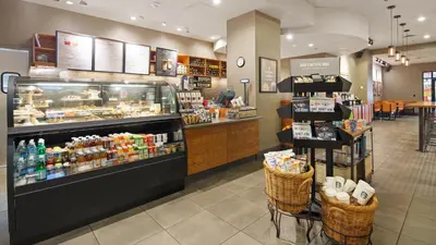 a store with a bakery with a counter with food at The Florida Hotel & Conference Center in the Florida Mall in Orlando