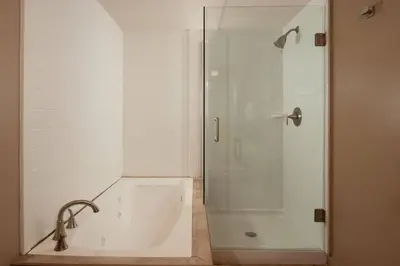 a bathroom with a shower and a bath tub at Delta Hotels by Marriott Orlando Lake Buena Vista in Orlando