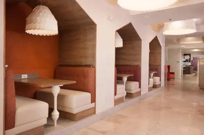 a restaurant with a table and chairs and lights at Delta Hotels by Marriott Orlando Lake Buena Vista in Orlando