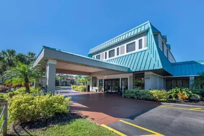 a large building with a blue roof at Hilton Vacation Club Aqua Sol Orlando West in Orlando