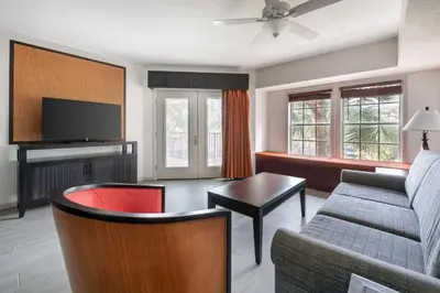 a living room with a couch and a tv at Hilton Vacation Club Aqua Sol Orlando West in Orlando