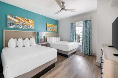 a hotel room with two beds and a ceiling fan at Hilton Vacation Club Aqua Sol Orlando West in Orlando