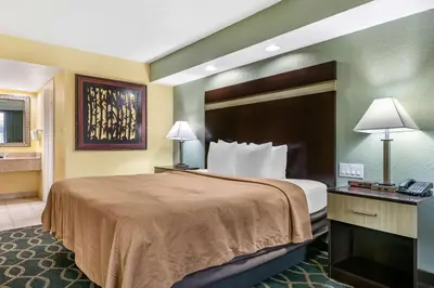 a hotel room with a bed and a telephone at Clarion Inn Orlando International Drive - ICON Park in Orlando