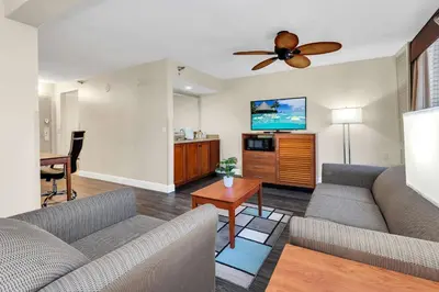 a living room with couches and a ceiling fan at Best Western Orlando Gateway Hotel in Orlando