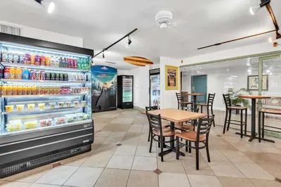a restaurant with a table and a refrigerator at Best Western Orlando Gateway Hotel in Orlando