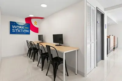 a conference room with a table with chairs and a computer at Howard Johnson by Wyndham Orlando Lake Buena Vista South in Kissimmee
