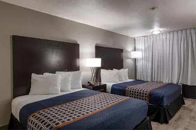 a hotel room with two beds and two lamps at Hotel Monreale Express International Drive Orlando in Orlando