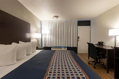 a hotel room with a large bed and a desk at Hotel Monreale Express International Drive Orlando in Orlando