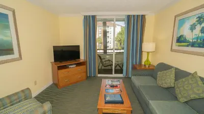 a living room with a couch and a tv at Blue Tree Resort at Lake Buena Vista in Orlando
