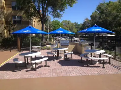 a group of tables and chairs with blue umbrellas at Blue Tree Resort at Lake Buena Vista in Orlando