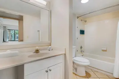 a white bathroom with a sink and a toilet at Parkway International Resort in Orlando