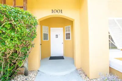 a hallway of a building with a white door at Berkley Lake Townhomes in Kissimmee